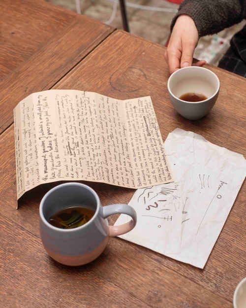 Notebooks and tea on a wooden table